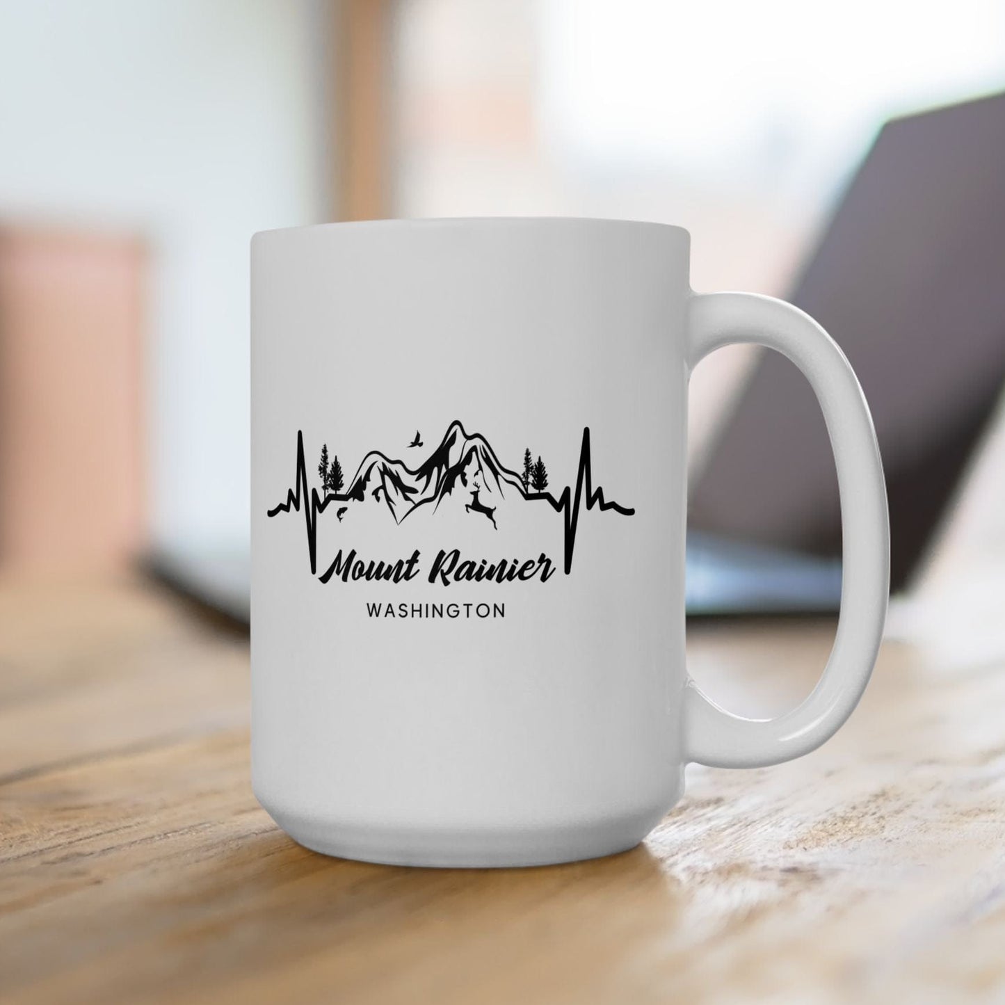 White mug with Mount Rainier design on a wooden surface