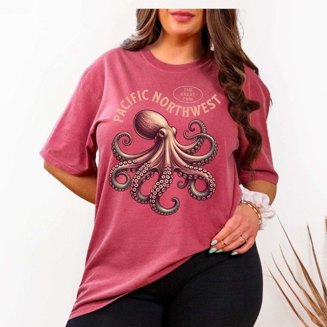 Person wearing a red t-shirt with an octopus graphic and 'Pacific Northwest' text, paired with a plaid shirt.