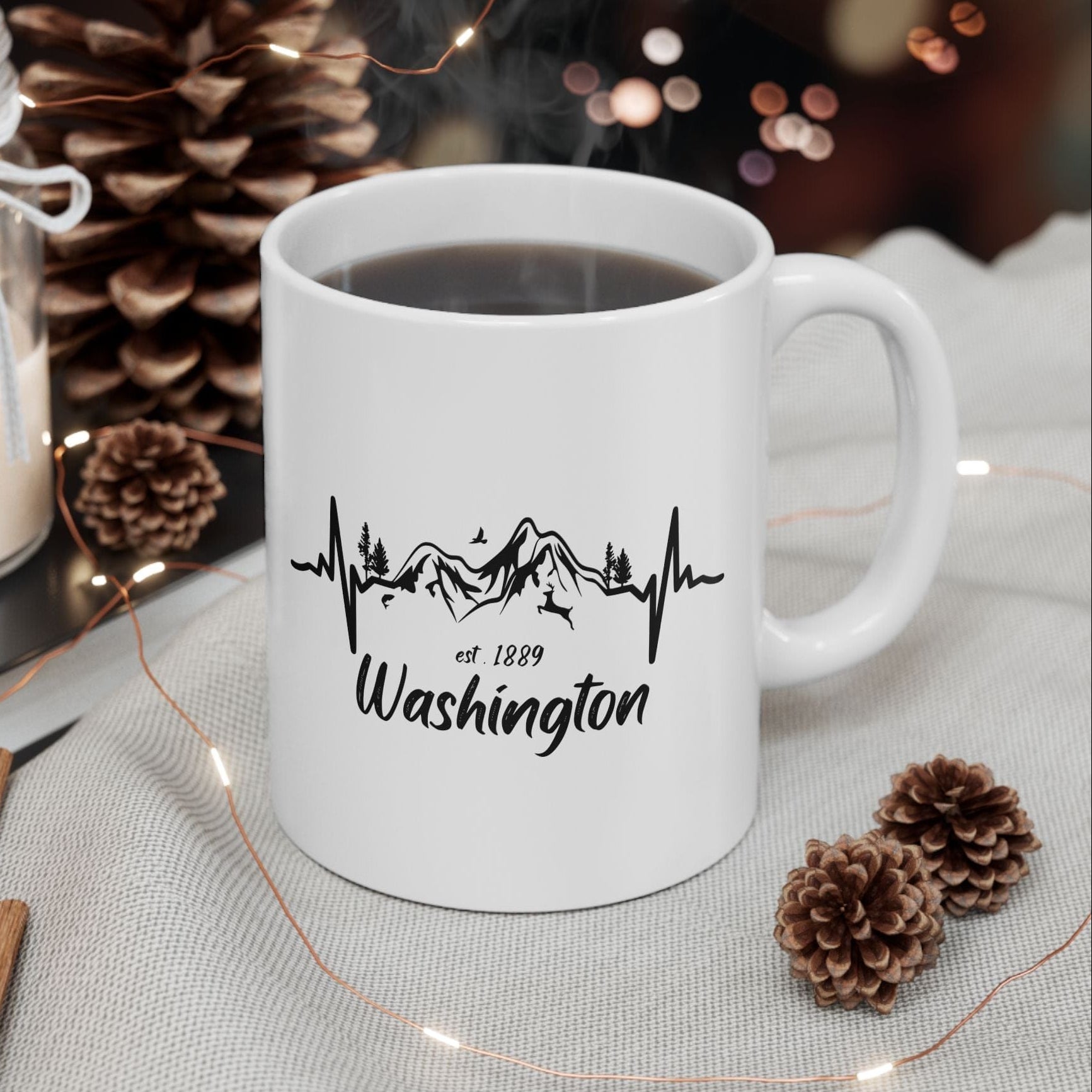 White mug with 'Washington' design on a table with decorative items