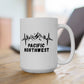 White mug with 'Pacific Northwest' design on a wooden surface
