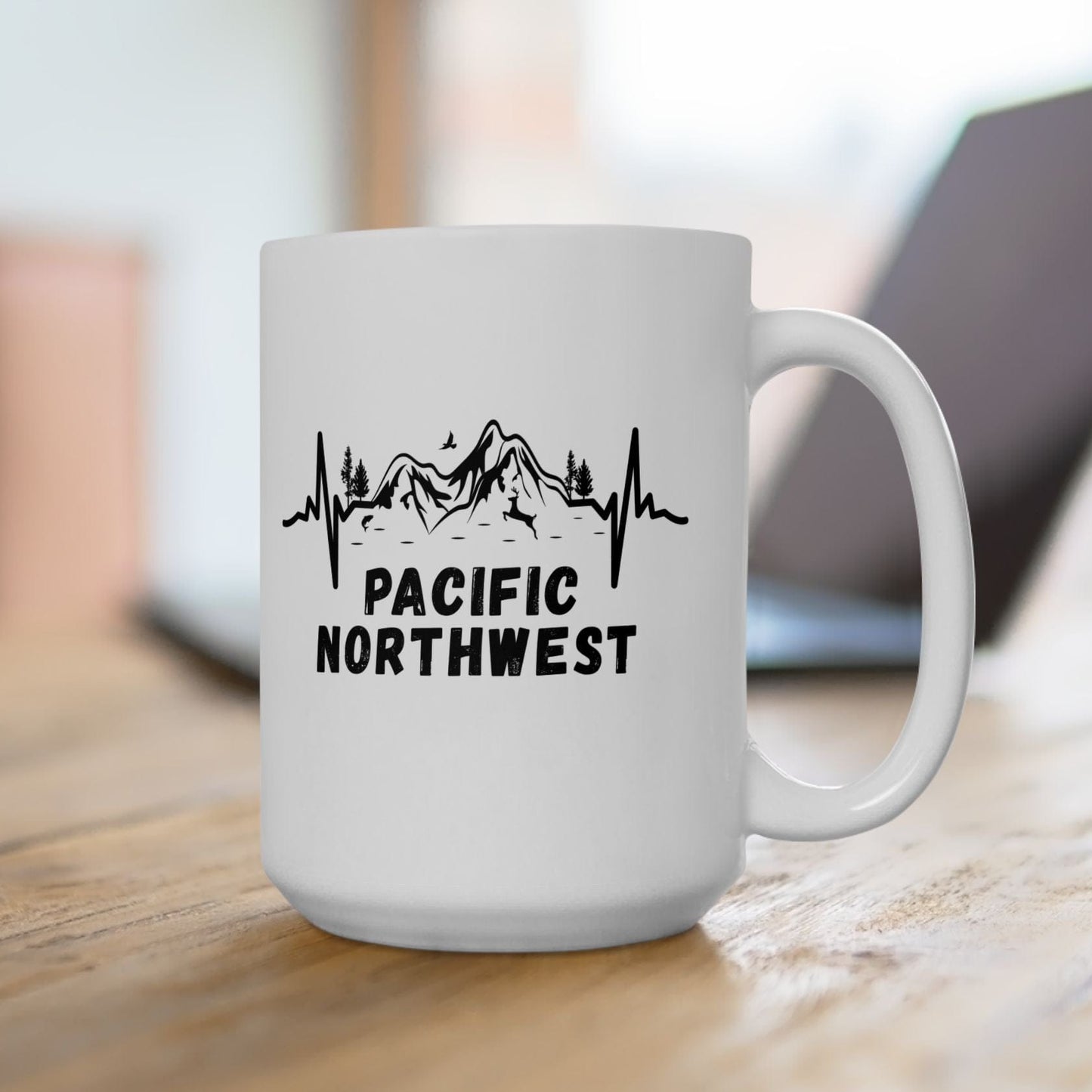 White mug with 'Pacific Northwest' design on a wooden surface