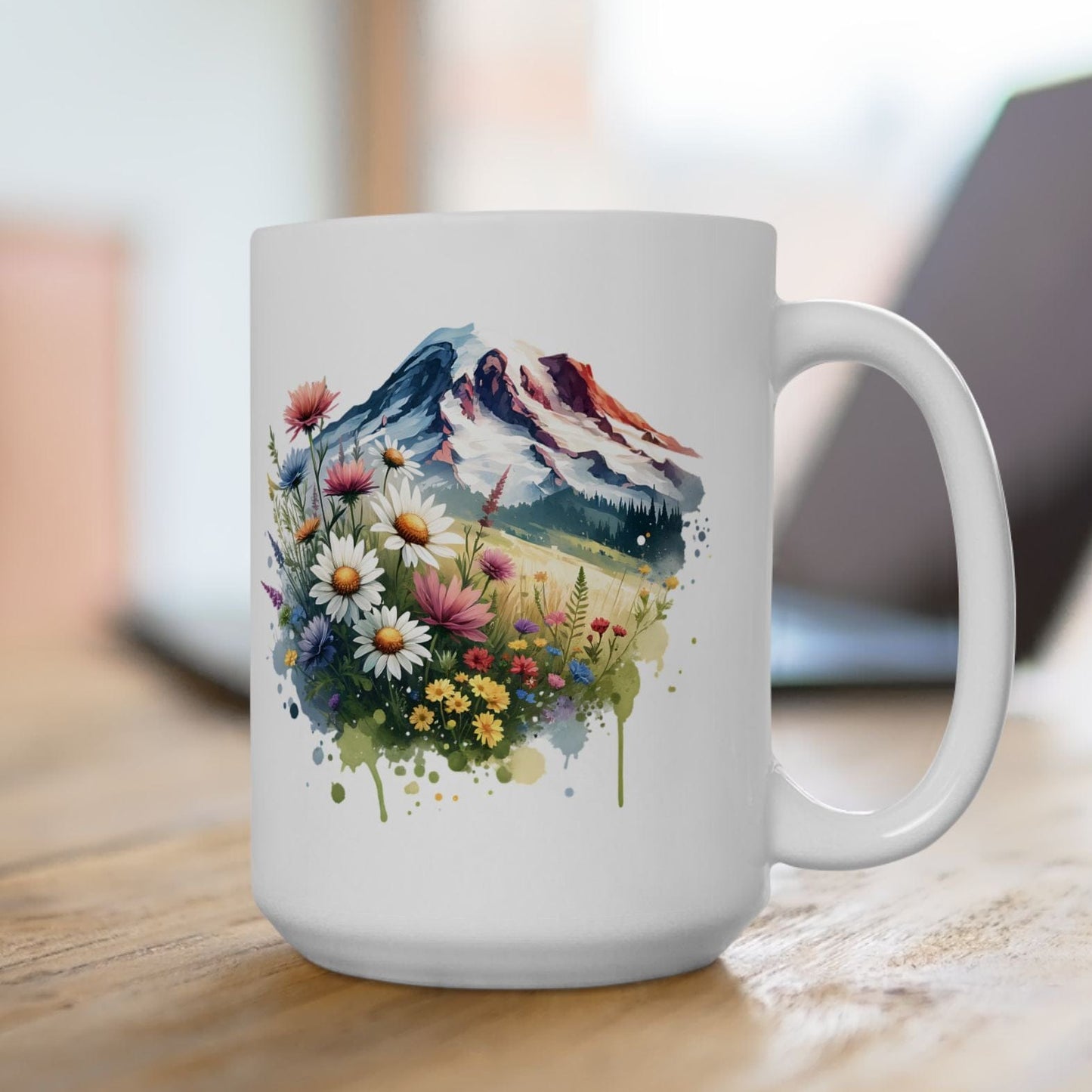 White mug with a mountain and floral design on a wooden surface