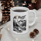 White mug with 'Mt. Rainier National Park' design on a table with decorative items.