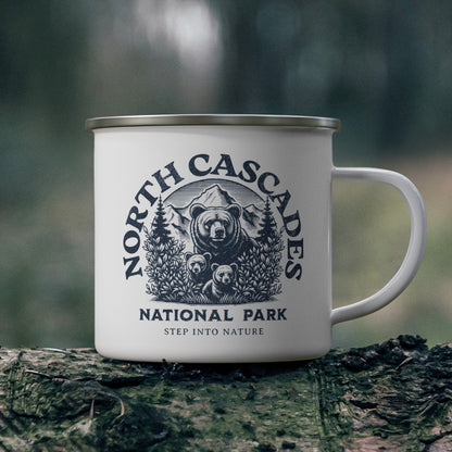 White mug with North Cascades National Park design on a log in a forest setting
