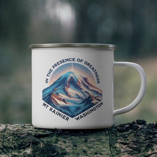 Mug with mountain design and text on a log in a forest setting
