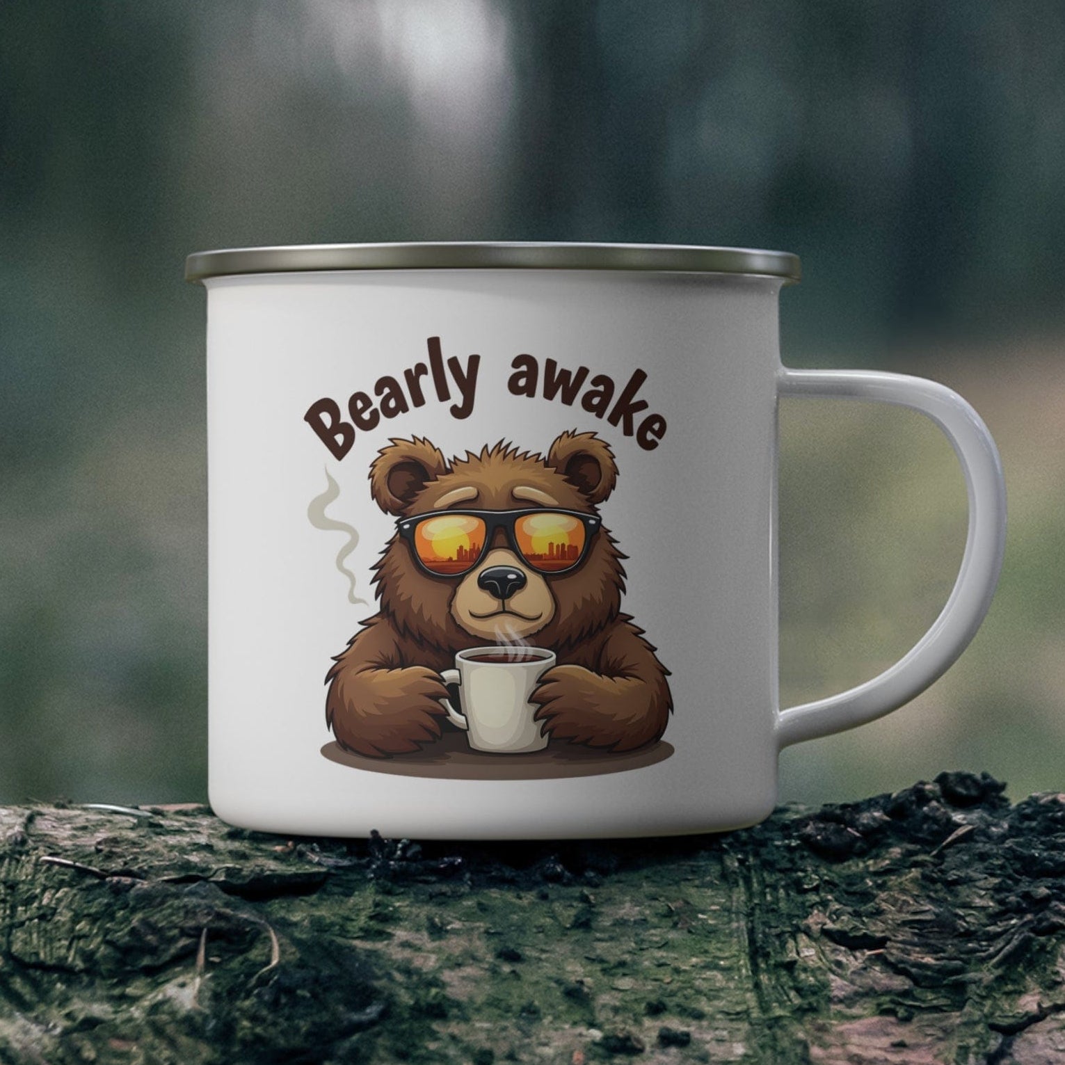 White mug with a bear design and 'Bearly awake' text on a wooden surface with a forest background.