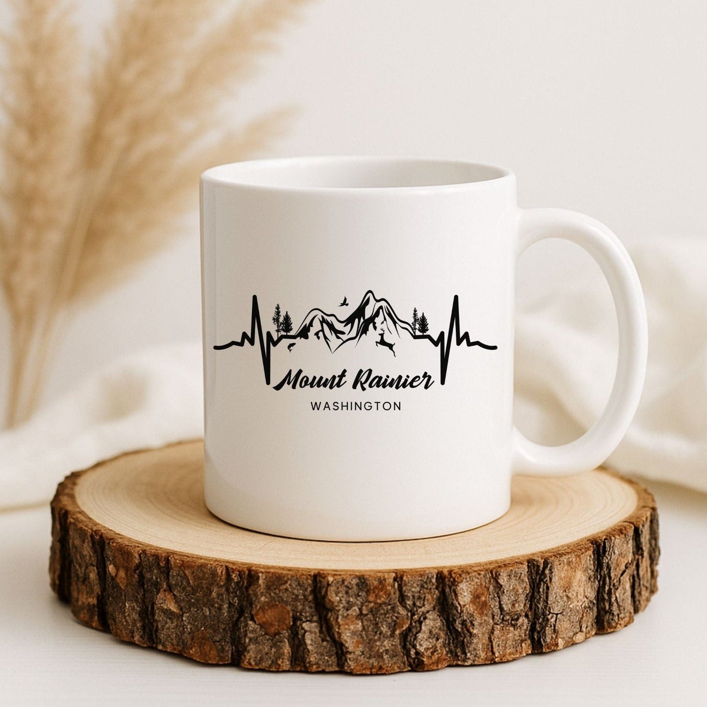 White mug with 'Mount Rainier Washington' design on a wooden coaster