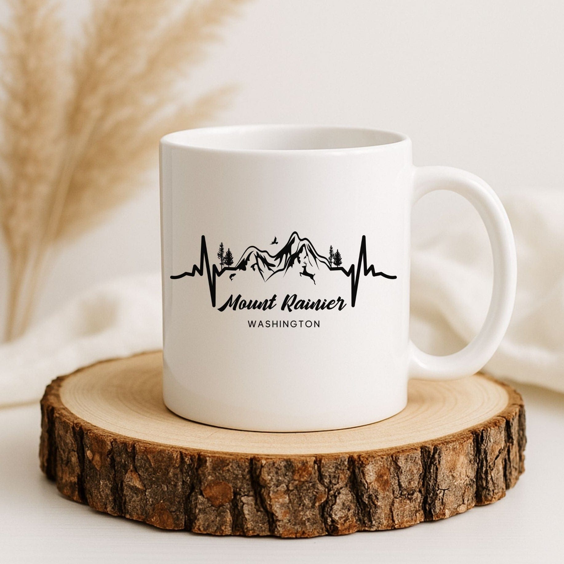 White mug with 'Mount Rainier Washington' design on a wooden coaster