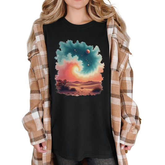 A woman wearing a vintage-style black tee with a desert swirl pattern, paired with a plaid shirt.