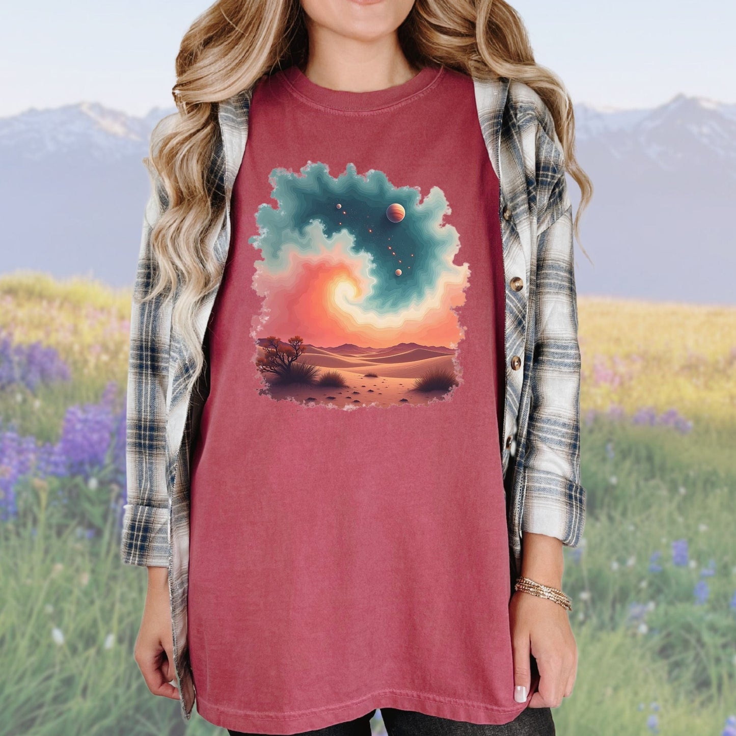 A woman wearing a vintage-style red tee with a swirl pattern, paired with a plaid shirt.