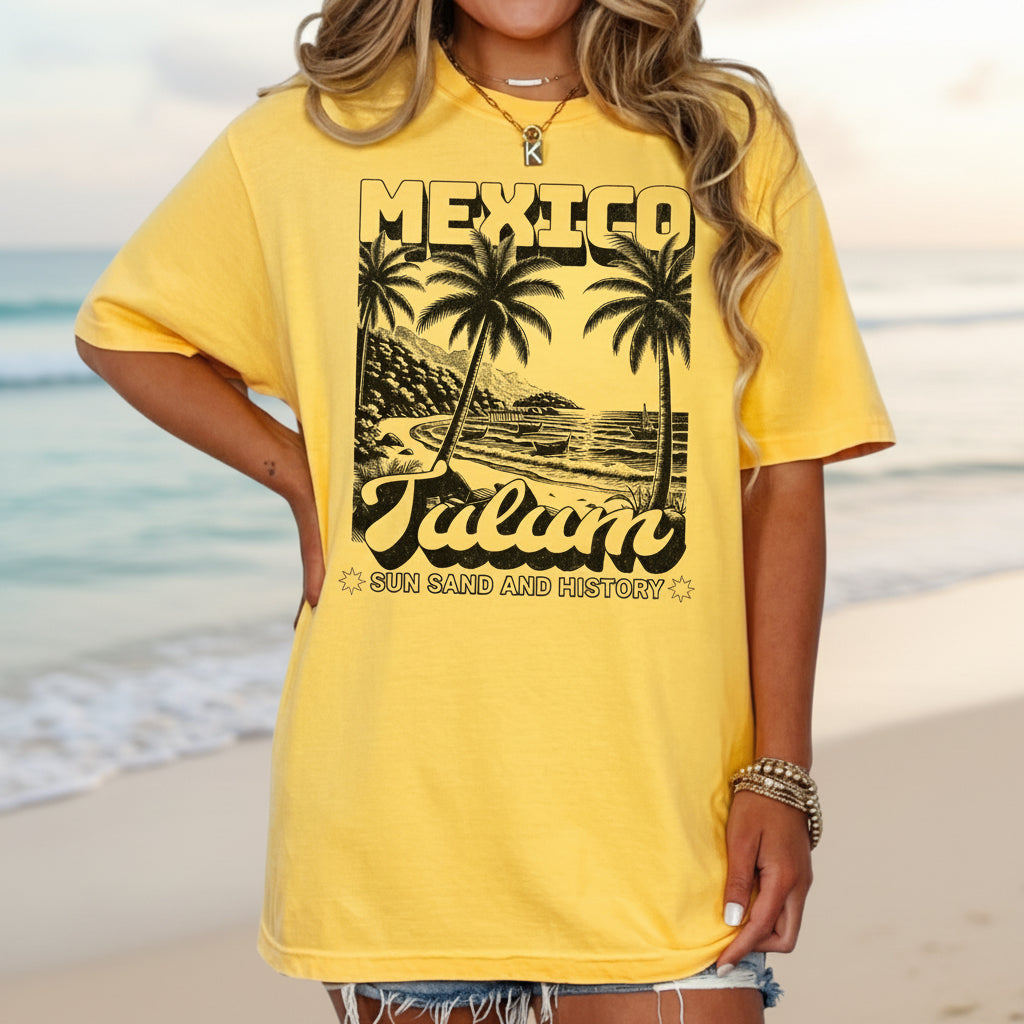 A yellow crew neck t-shirt with a vintage-style graphic print of palm trees and the text 'MEXICO Tulum'.