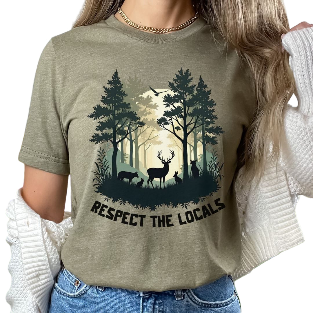 A person wearing a green t-shirt with a graphic of a forest and deer and the text 'RESPECT THE LOCALS'.