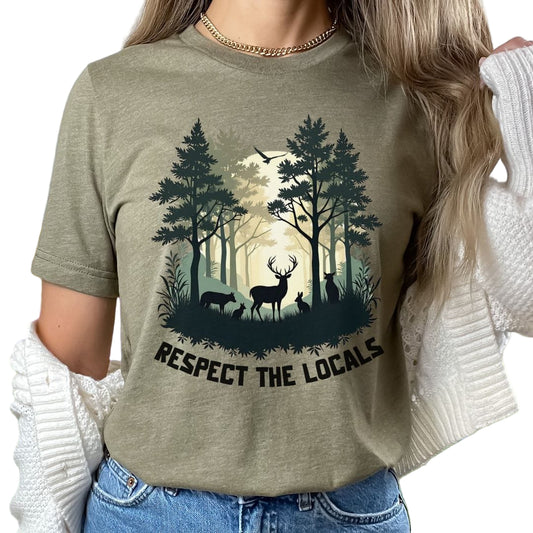 A person wearing a green t-shirt with a graphic of a forest and deer and the text 'RESPECT THE LOCALS'.