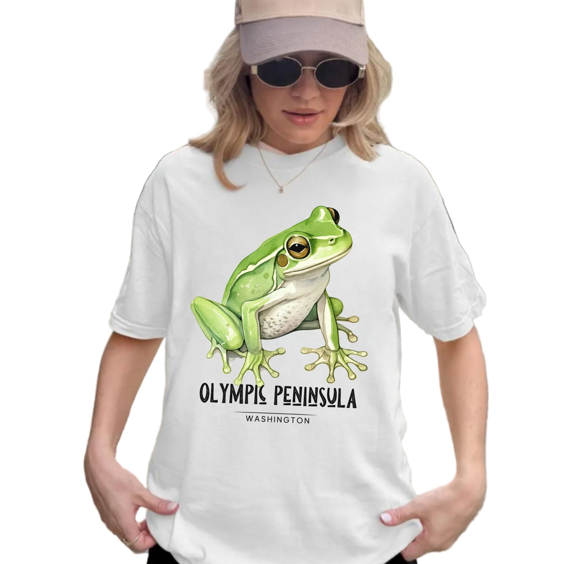 Person wearing a white t-shirt with a green frog graphic and the words, Olympic Peninsula, Washington.