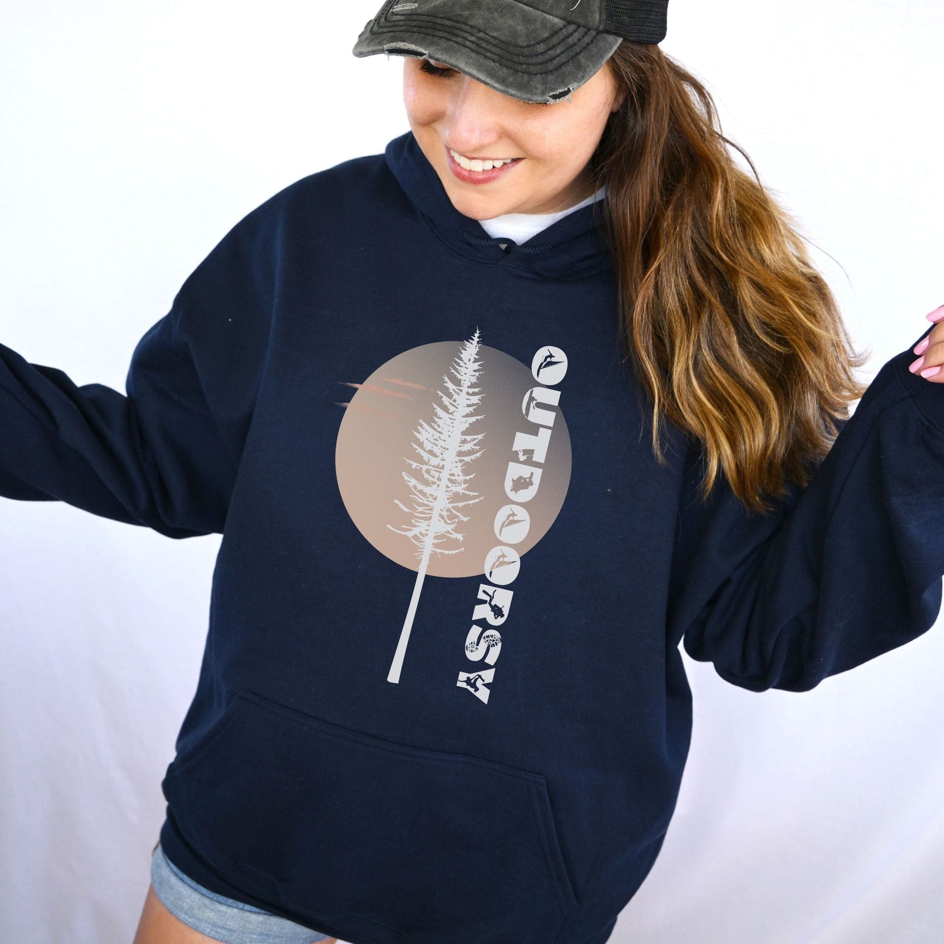 Person wearing a navy hoodie with a tree graphic and 'Outdoor' text on a white background