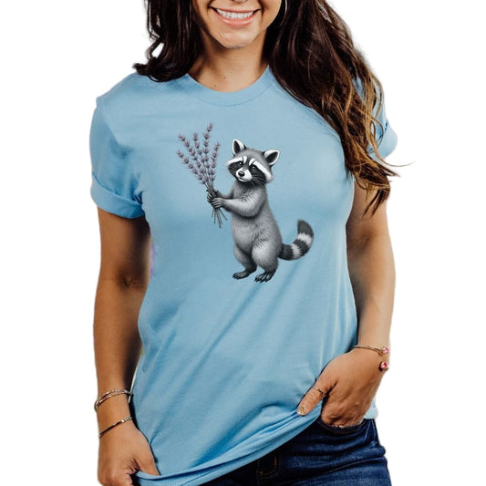 A woman wearing a blue t-shirt with a graphic of a raccoon and lavender plants.