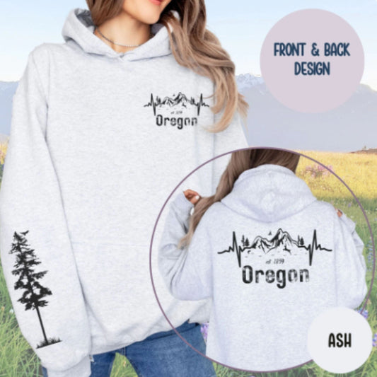 Gray hoodie with 'Oregon' design on front and back, outdoors setting