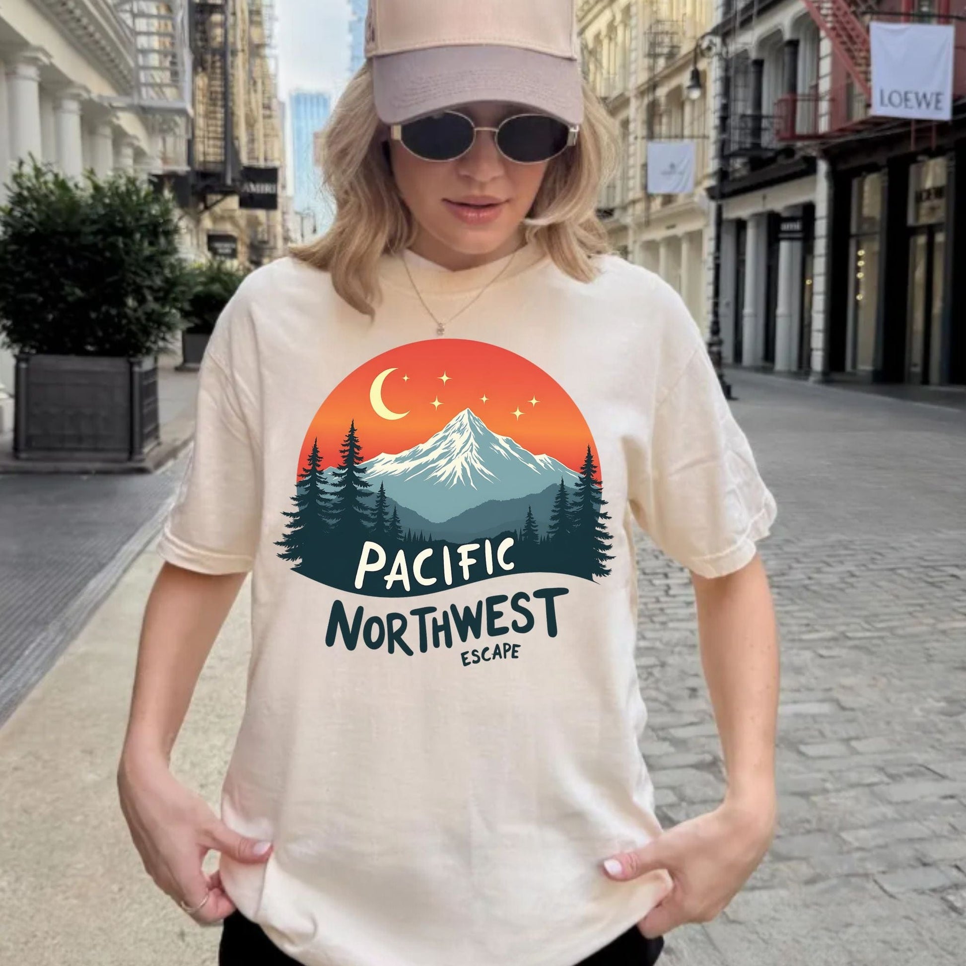 Person wearing a t-shirt with a Pacific Northwest design on a city street.