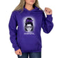 A woman wearing a purple hoodie with an illustration of a girl's face, sunglasses, and the text 'PNWGRL'.