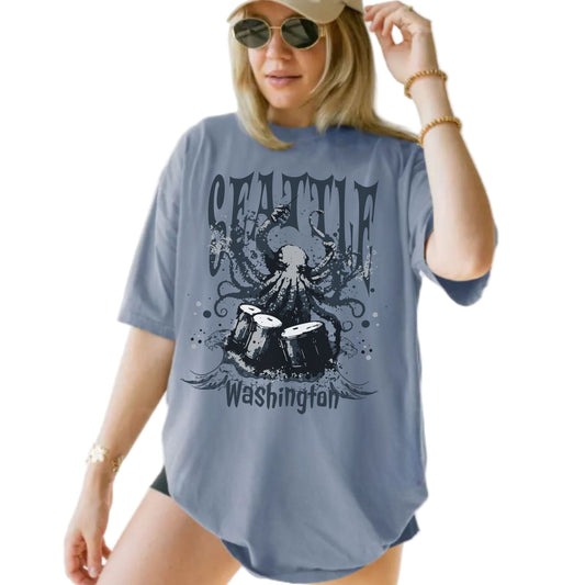 Person wearing a blue t-shirt with 'Seattle Washington' design.
