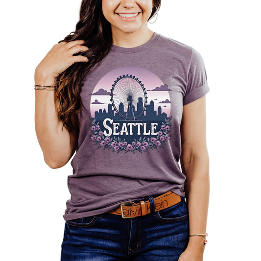 Person wearing a purple t-shirt with 'Seattle' design on a plain background