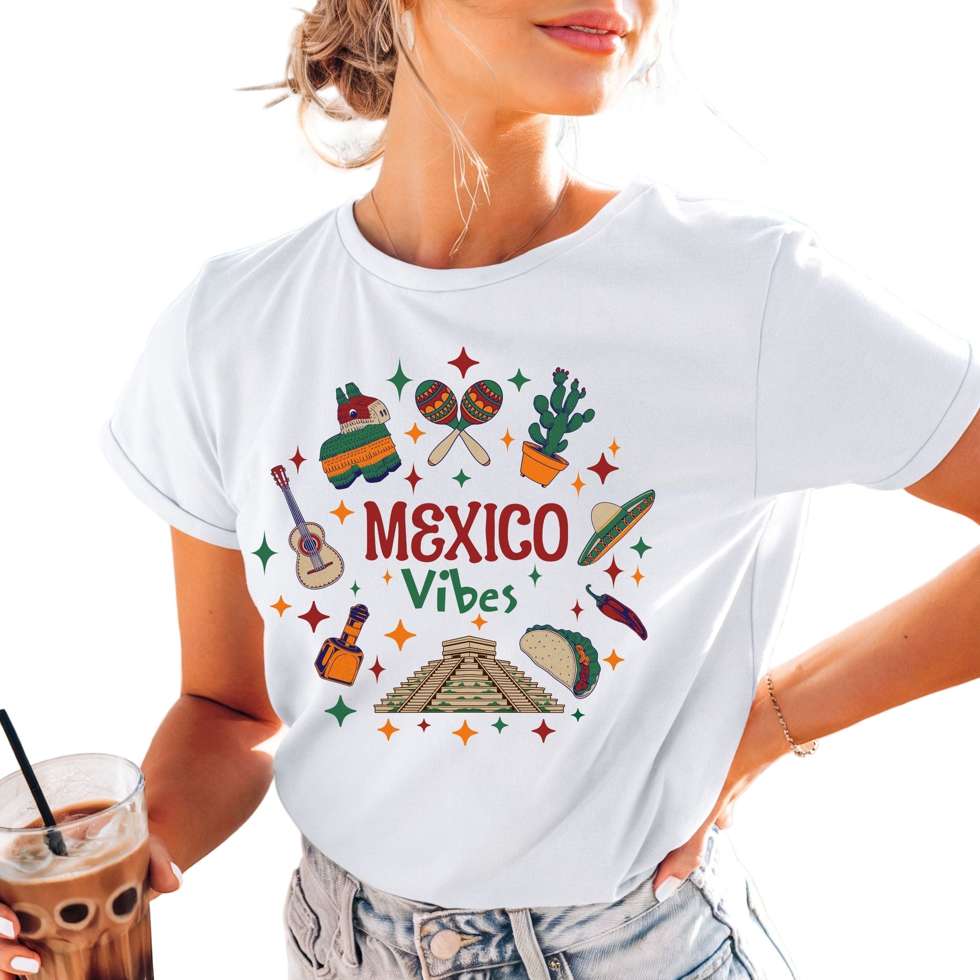A person wearing a white t-shirt with 'MEXICO VIBES' text and colorful illustrations, such as a guitar and cacti, on the front.