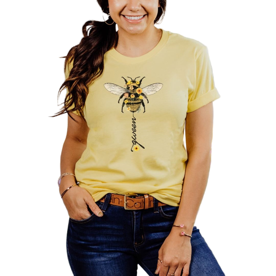 A woman wearing a yellow t-shirt with a bee design and the word 'queen' on it.