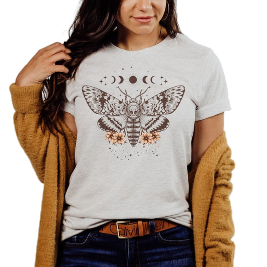 A person wearing an ash colored t-shirt with a celestial moth design.