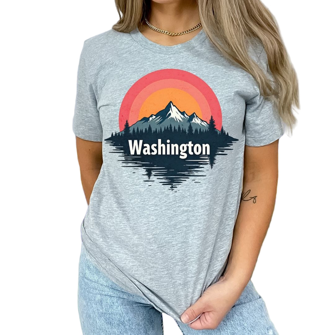 A person wearing a gray t-shirt with a graphic of a sunrise over a mountain range, and the text 'Washington' below it.