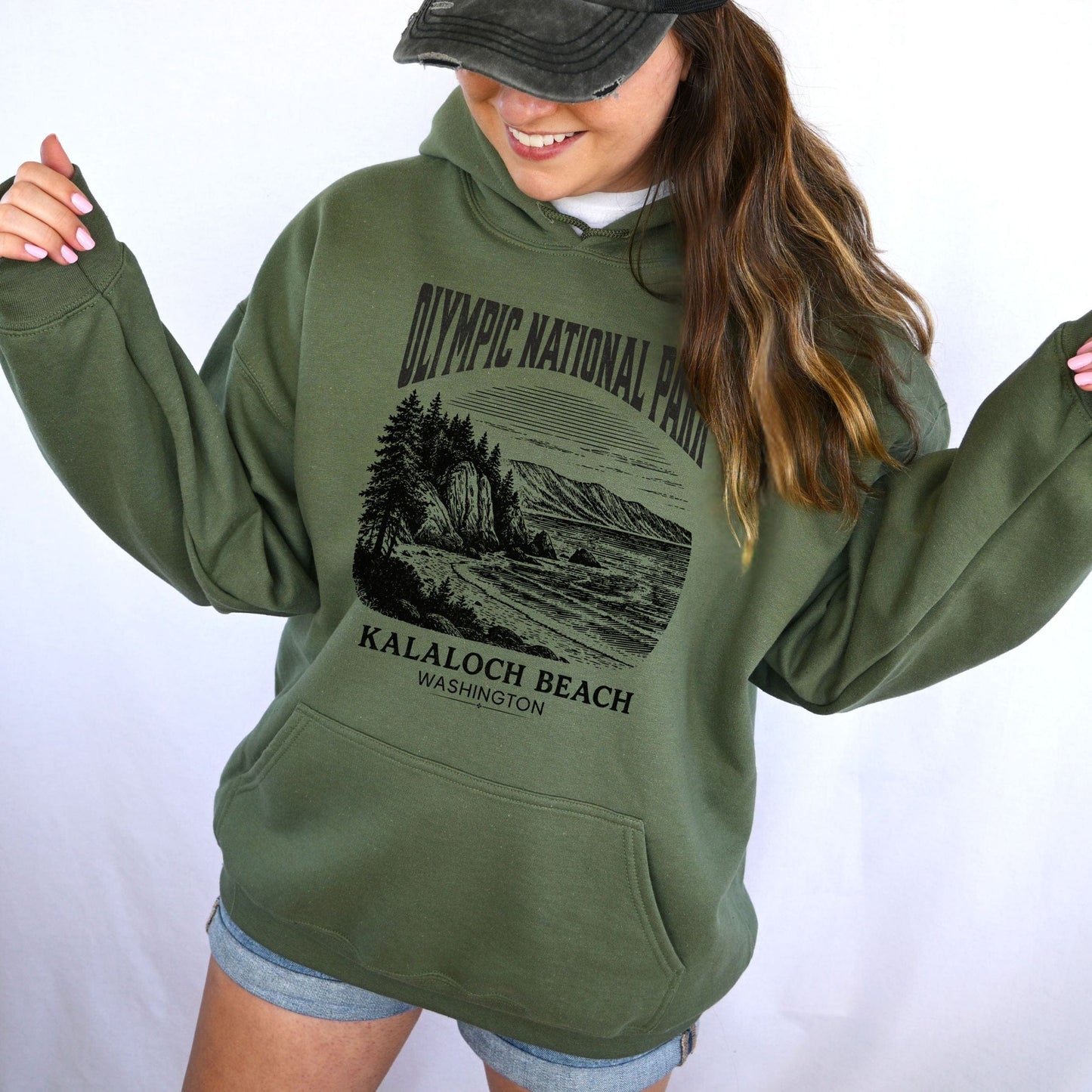 Person wearing a green hoodie with Olympic National Park design on a white background