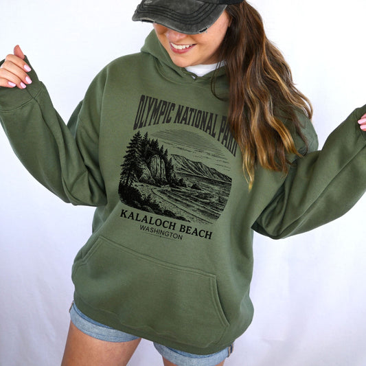 Person wearing a green hoodie with Olympic National Park design on a white background