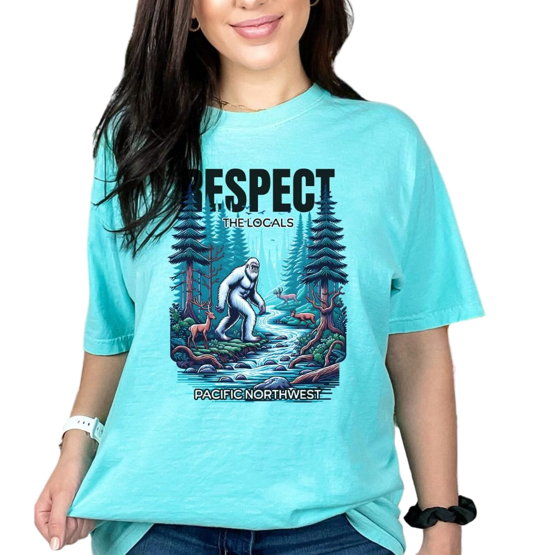 Person wearing a turquoise t-shirt with a graphic design and text.