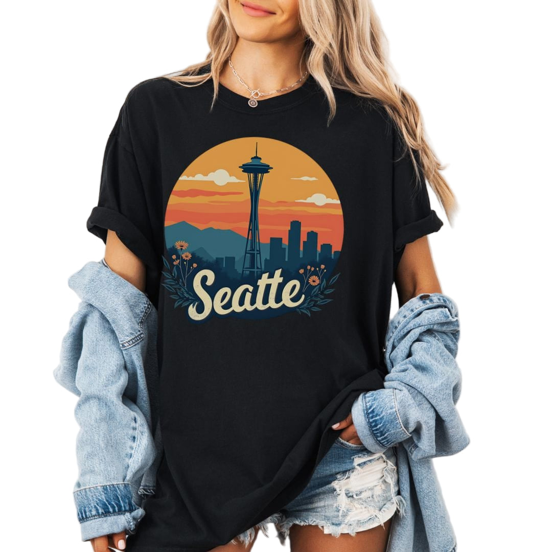 Person wearing a black t-shirt with a Seattle-themed graphic design.